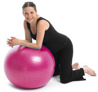 Pregnant woman leaning on birth ball